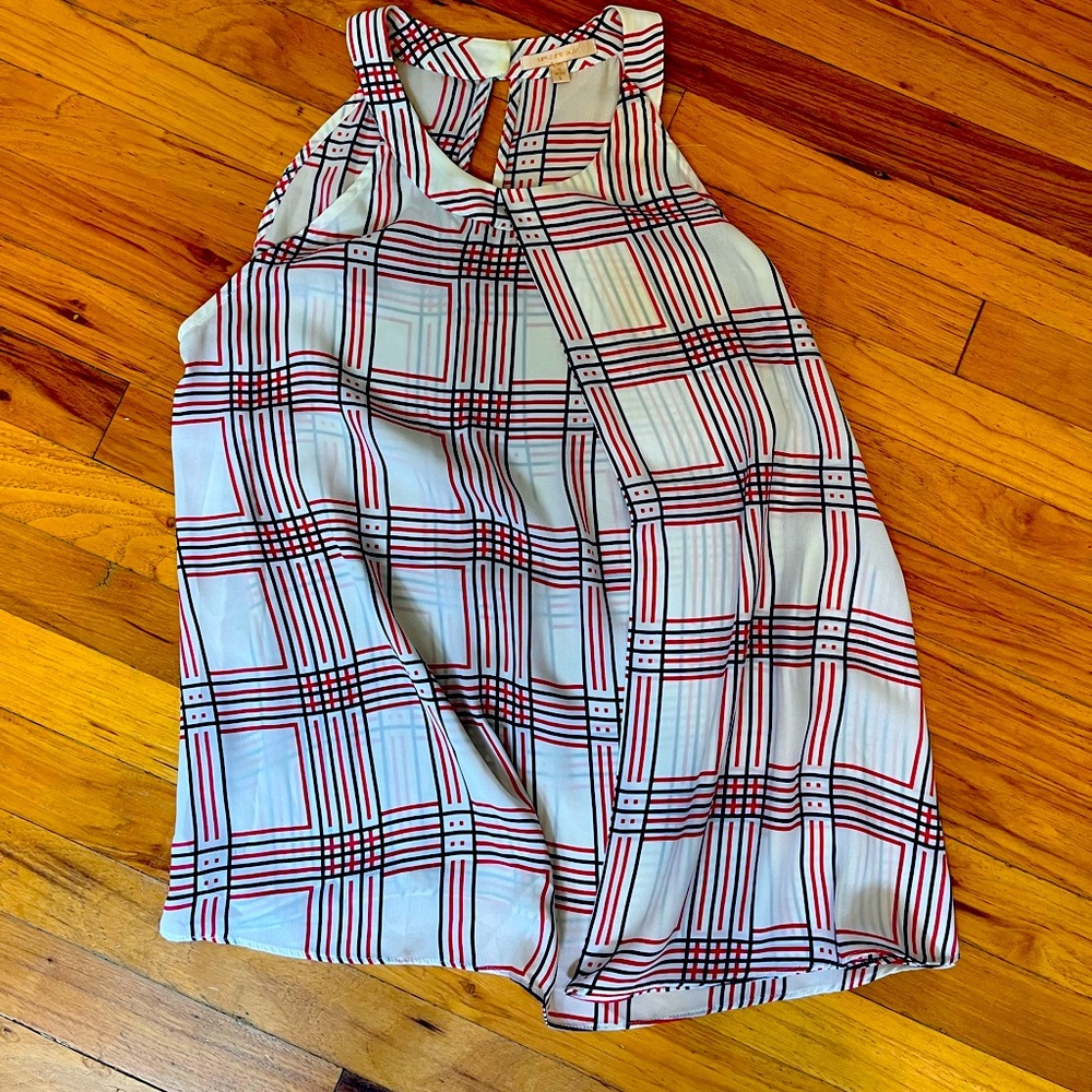 High neck, flowy, plaid, sleeveless blouse.